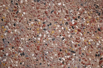 Urban background - small red stones in a wall