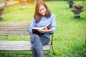 Hipster charming girl relaxing in the park while read book, Enjoy
