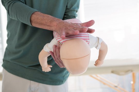Paramedic demonstrating resuscitation on a infant dummy