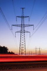 High voltage electricity pylon system and tracks from traffic.