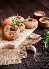 Obraz na płótnie Canvas Rye flour buns with Schwarzwald ham, garlic, cumin, rosemary and Himalayan salt