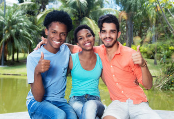 Group of happy african american and latin man and woman showing
