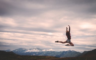 Young man jump in mountains