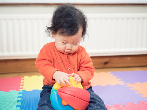Asian baby playing building blocks toys