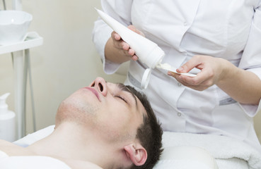 Fototapeta premium Man in the mask cosmetic procedure in spa salon