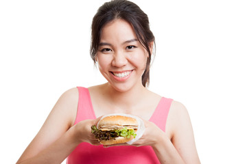 Beautiful Asian healthy girl enjoy eating  hamburger.