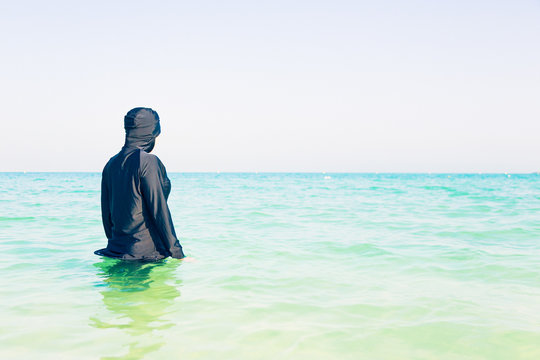 Young Woman In Burkini Swimming In The Sea