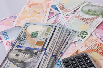  American dollar banknotes and Turksh Lira banknotes side by sid