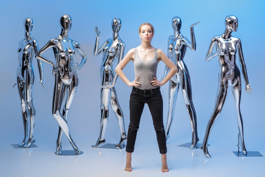 attractive woman on background of many  metallic shiny mannequin