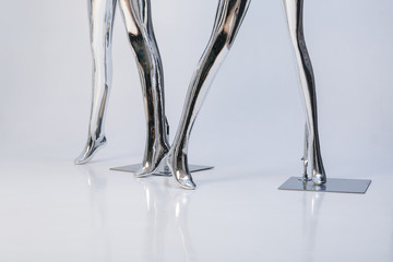 many fashion shiny female mannequins for clothes. Metallic manne