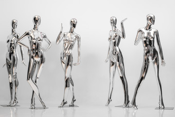 many fashion shiny female mannequins for clothes. Metallic manne - obrazy, fototapety, plakaty