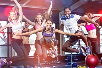 Fit group smiling and jumping - obrazy, fototapety, plakaty
