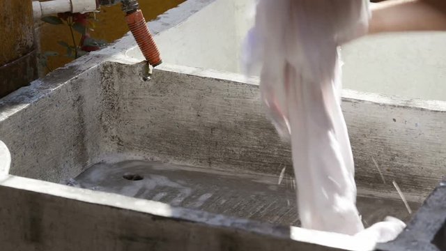 Hand washing clothes in outdoor laundry in a developing country