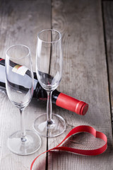 two champagne glasses with red ribbon heart shape .valentines da