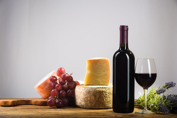 Red wine in vintage light with cheese and fruits. - 134783009