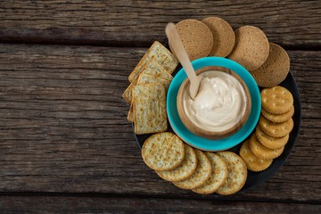 Cheese sauce with biscuits in black plate