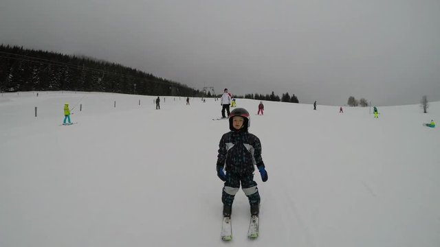 Skiing lessons. Ski school.
Little boy learning to ski.