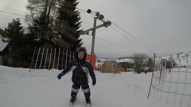 Skiing lessons. Ski school.
Little boy learning to ski.