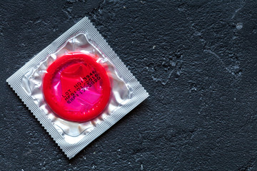 concept male contraception condom on dark background top view
