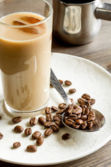 coffee with ice in glass on wooden background