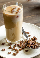 coffee with ice in glass on wooden background