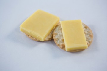 Cheese with crackers on white background
