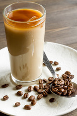 coffee with ice in glass on wooden background