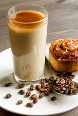 coffee with ice in glass on wooden background