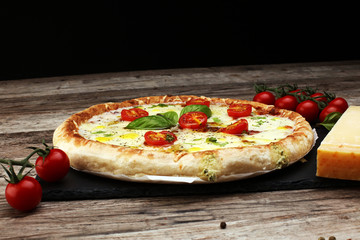 Hot true PEPPERONI ITALIAN PIZZA with salami and cheese. TOP VIEW Tasty traditional pepperoni pizza on board on wooden table with decoration