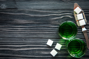 absinthe in glass on wooden background top view mock up