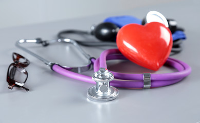 Red heart and a stethoscope on white background