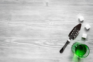 absinthe in glass on wooden background top view mock up