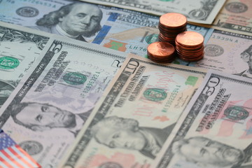 Fototapeta premium US Dollar cash background, banknote and coin stack with US flag sign, finance and economy concept