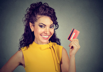 Happy woman holding credit card