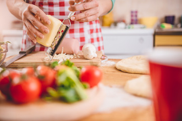 Woman Grating Cheese