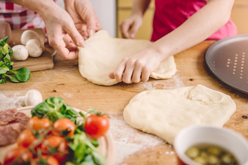 Mother and daughter preparing pizza