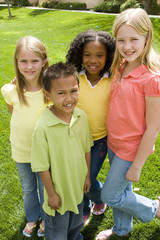 Happy diverse group of kids outside at a park.