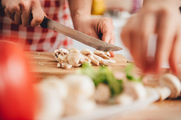 Woman slicing mushroom