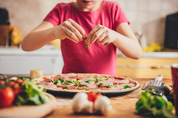 Girl preparing pizza