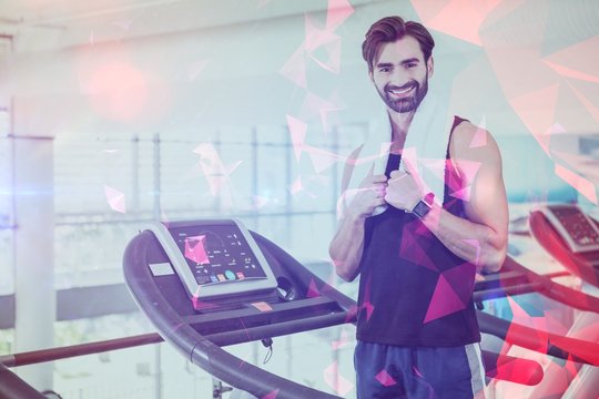 Portriat of smiling man standing on treadmill