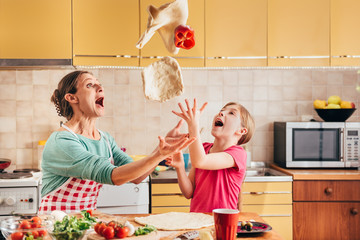 Mother and daughter preparing pizza