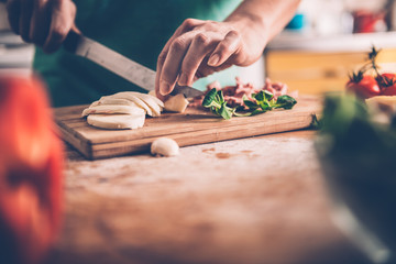 Woman slicing mozzarella cheese