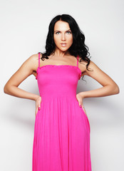 young woman in pink dress posing on white  background