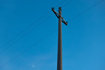 Old light pole and blue sky with moon