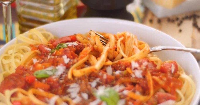 Dolly close up push in view of  Italian pasta (spaghetti, linguini) with tomato sauce
