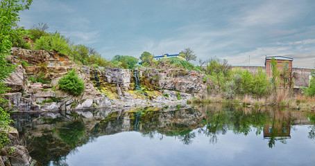 Panoramic view over a landscape of lake, rock and forest