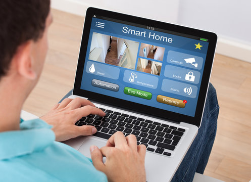 Man Using Smart Home System On Mobilephone