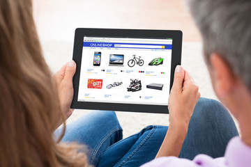Couple Shopping Online On Digital Tablet