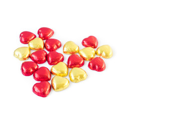 Red and gold heart shape chocolate on white background, lover co