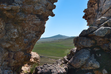 Hilly Steppe landscape view between two rocks